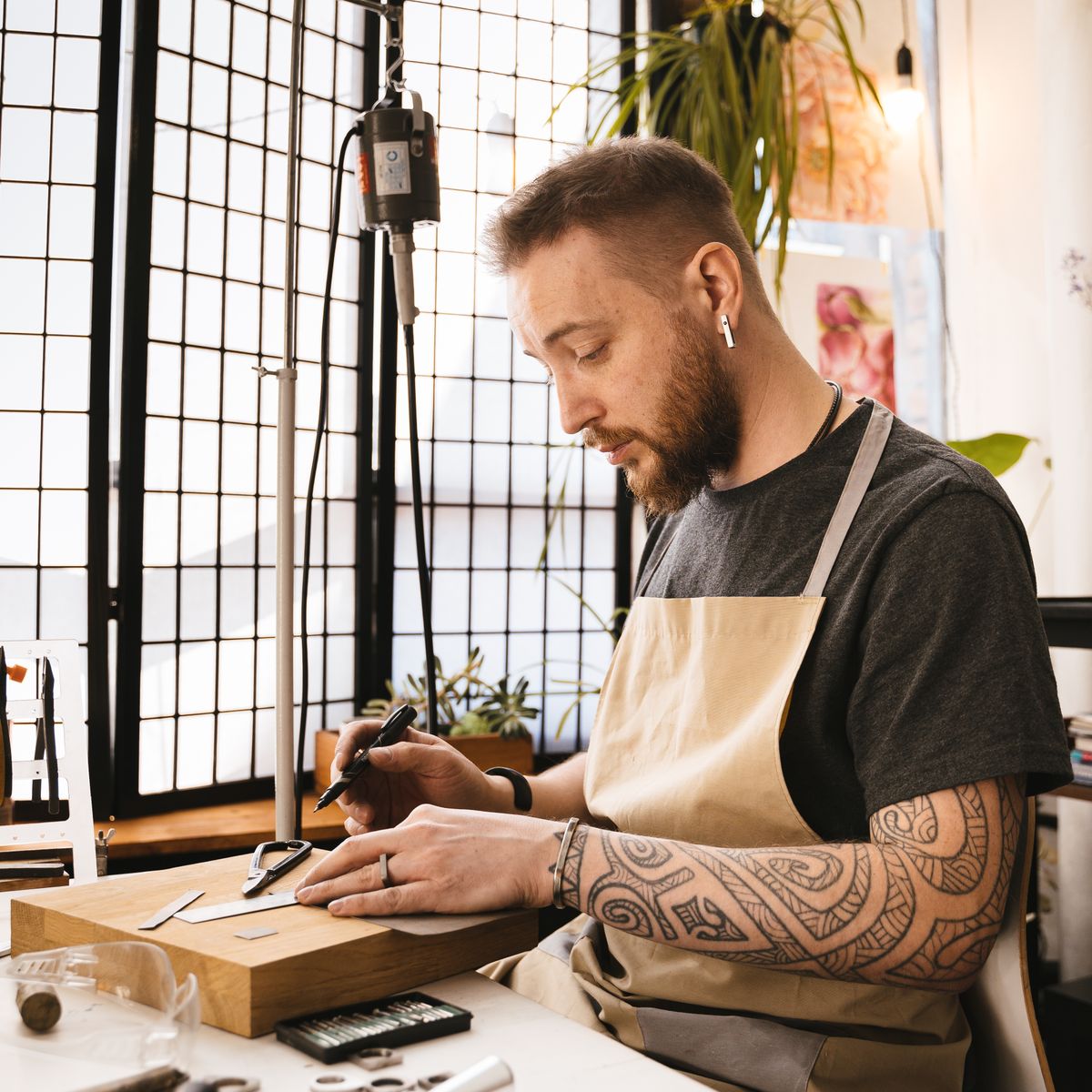 Artisan concentré sur son métier dans son atelier, pendant qu'AutoFlow s'occupe de l'administratif